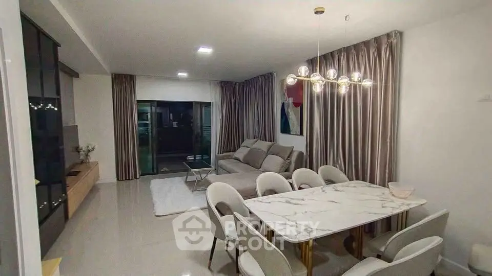 Elegant living room with modern dining area and stylish lighting in a contemporary apartment.