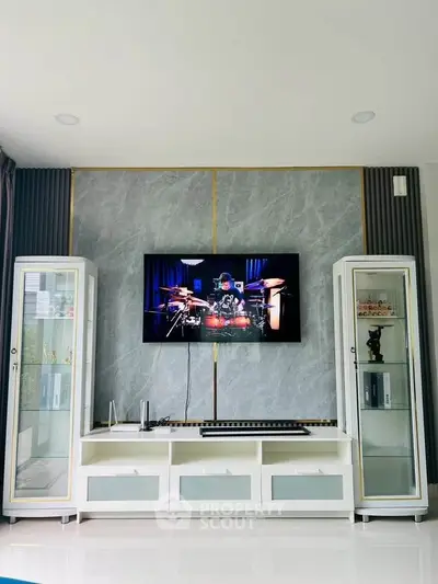 Stylish living room with modern entertainment center and sleek display cabinets.