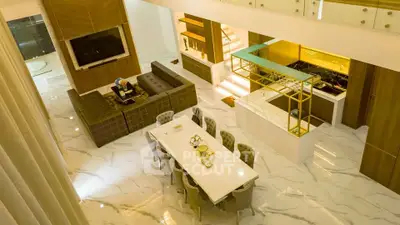 Luxurious open-plan living and dining area with modern decor and marble flooring