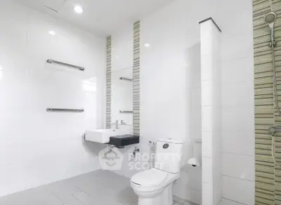 Modern bathroom with sleek white tiles and contemporary fixtures