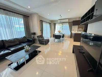 Spacious modern living room with open kitchen and elegant furnishings