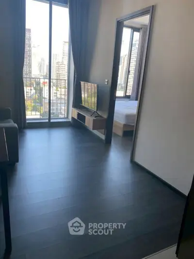 Modern apartment with city view, sleek flooring, and open layout near balcony.