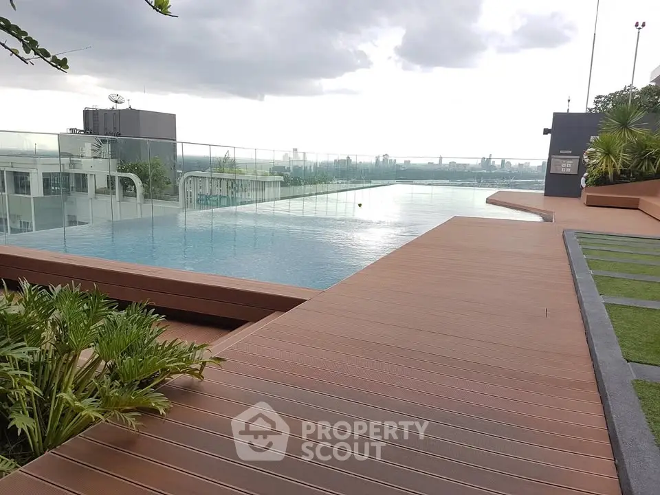 Luxurious rooftop pool with stunning city view and modern deck design.