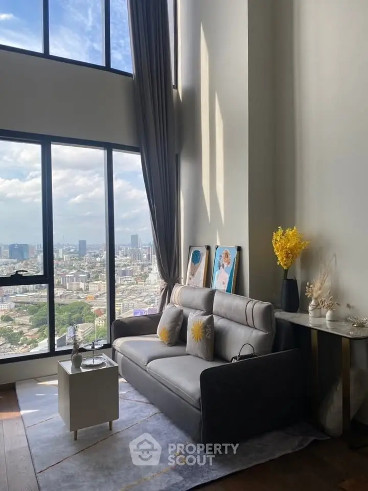 Stunning high-rise living room with floor-to-ceiling windows and breathtaking city view.