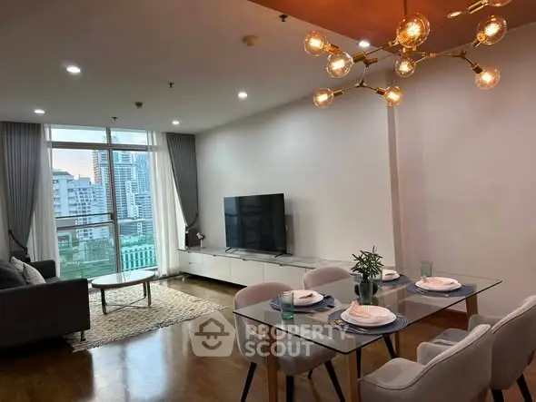 Modern living room with elegant dining area and city view, featuring stylish lighting and contemporary decor.