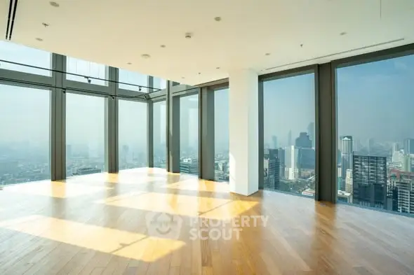 Stunning corner unit with panoramic city views and floor-to-ceiling windows in a high-rise building.