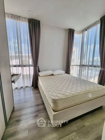 Bright and airy bedroom with large windows and modern decor