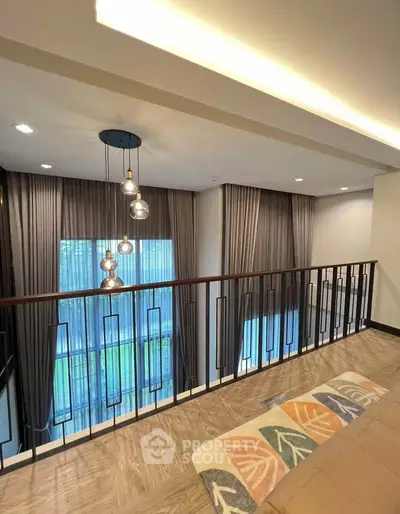 Stylish modern interior with elegant lighting and floor-to-ceiling windows in a spacious living area.