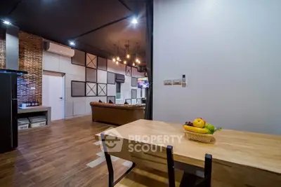 Modern open-plan living room with stylish decor and wooden flooring