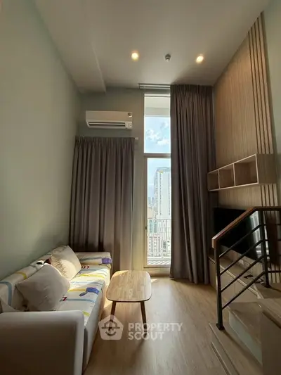 Modern living room with high ceiling and city view, featuring cozy sofa and stylish decor.