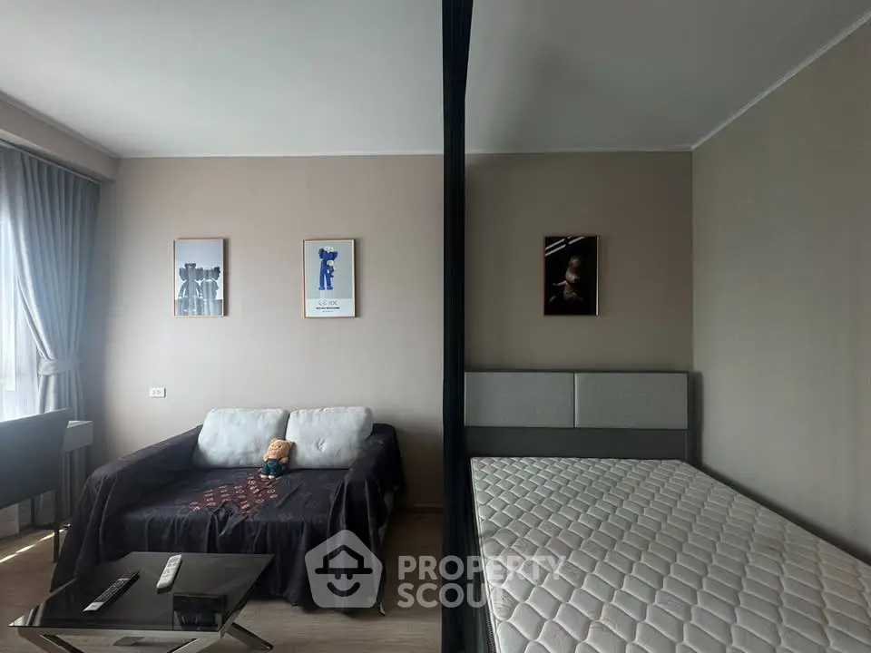 Modern studio apartment with cozy living area and comfortable bed, perfect for urban living.