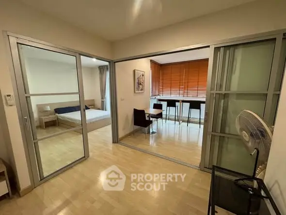 Spacious modern apartment with sliding glass doors and wooden flooring