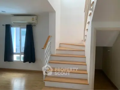 Modern interior with wooden staircase and air-conditioned living space