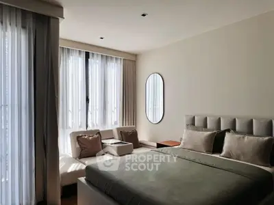 Elegant bedroom with modern decor and ample natural light