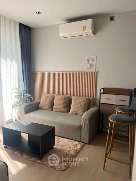 Modern living room with cozy sofa, stylish decor, and natural light, perfect for relaxation and entertaining.