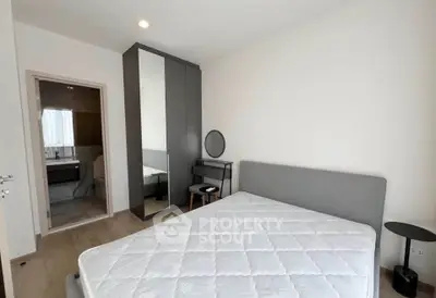 Modern bedroom with ensuite bathroom and stylish furniture in a contemporary apartment.