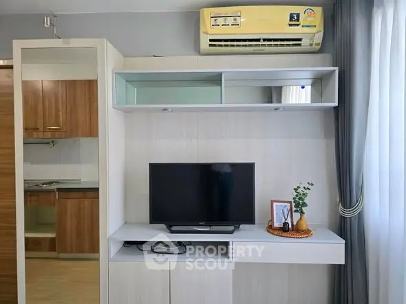 Modern living room with TV, air conditioner, and stylish decor