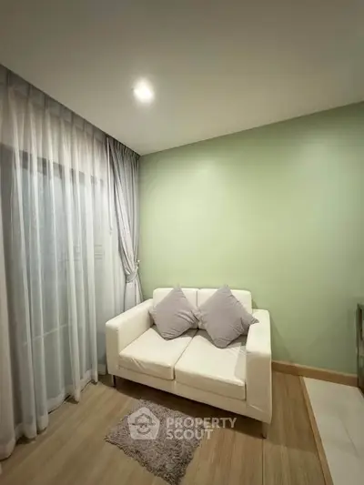 Cozy living room with white sofa and soft lighting, perfect for relaxation.