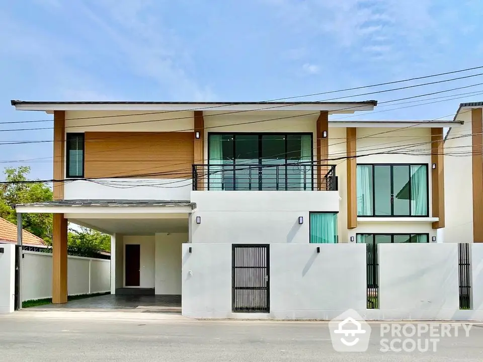 Modern two-story house with sleek design, large windows, and a spacious driveway, offering contemporary living.