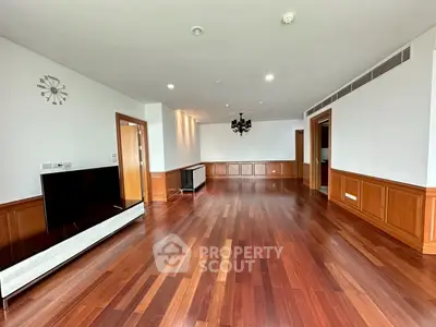 Spacious living room with elegant wooden flooring and modern decor