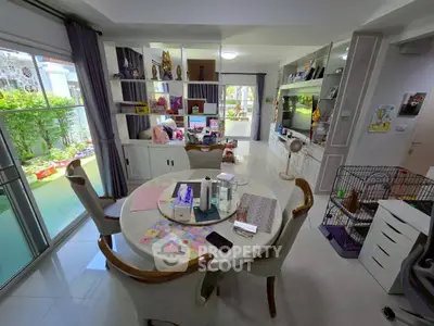 Spacious living room with elegant dining area and garden view, perfect for family gatherings.
