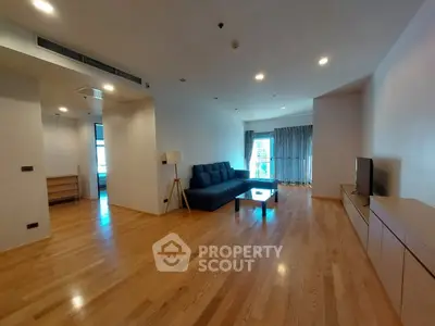 Spacious modern living room with wooden flooring and stylish furniture