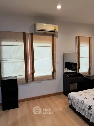 Cozy bedroom with modern air conditioning and stylish decor