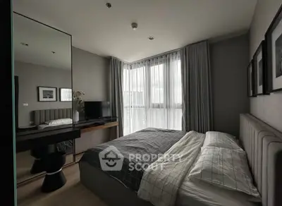 Modern bedroom with stylish decor and large windows for natural light