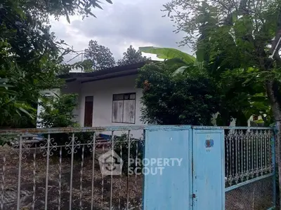 Charming single-story home with lush garden and secure gated entrance.