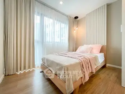 Cozy modern bedroom with natural light and stylish decor in a real estate property.