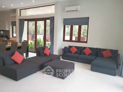 Spacious modern living room with stylish furniture and large windows for natural light.