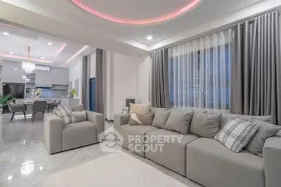 Spacious modern living room with elegant decor and open kitchen layout