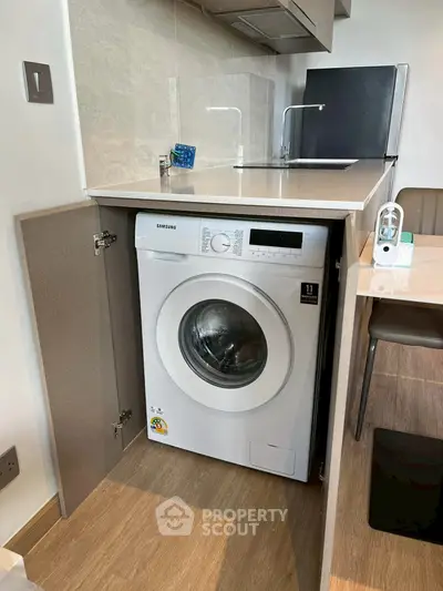 Modern kitchen with built-in washing machine and sleek appliances