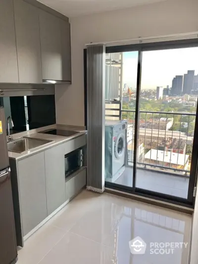 Modern kitchen with sleek design and balcony view in urban apartment