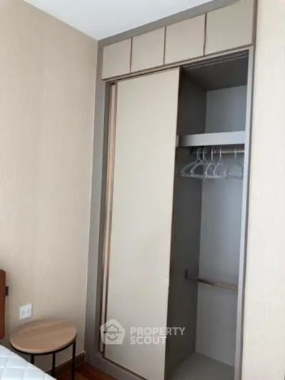 Modern bedroom with built-in wardrobe and stylish side table