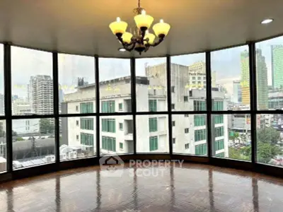 Spacious corner unit with panoramic city views and elegant chandelier.