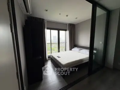 Modern bedroom with large window and city view
