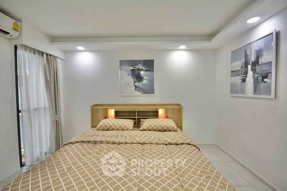 Modern bedroom with stylish decor and natural light in a cozy apartment.