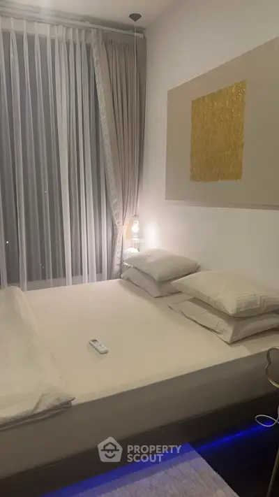 Elegant bedroom with modern decor and ambient lighting, featuring a cozy bed and stylish curtains.