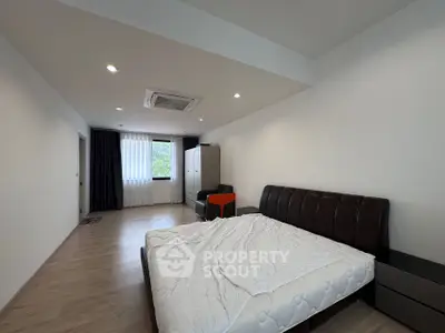 Spacious modern bedroom with stylish furniture and natural light