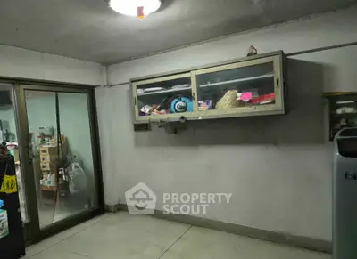 Spacious storage room with sliding glass door and wall-mounted cabinet.