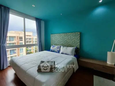 Bright bedroom with large window and modern decor in urban apartment