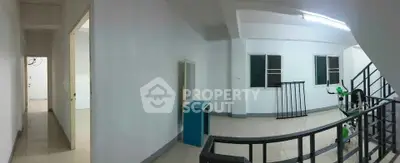 Spacious interior hallway with modern staircase and natural light