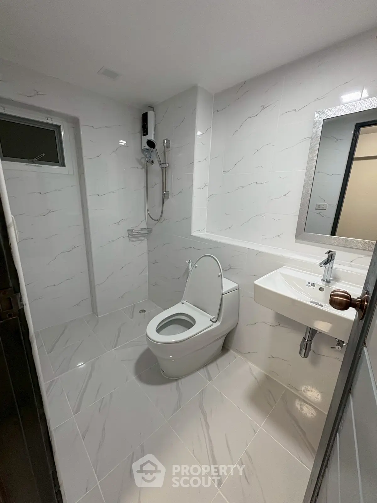 Modern bathroom with sleek white tiles and contemporary fixtures