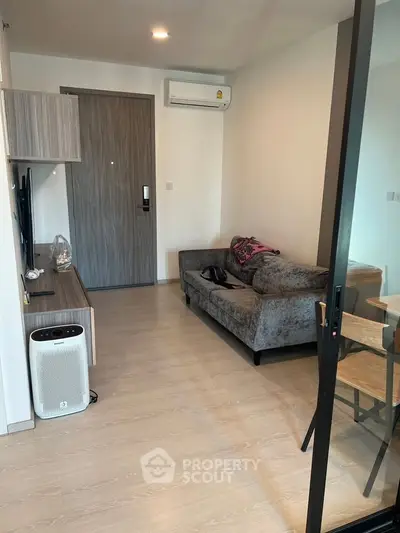 Modern living room with sleek furniture and air conditioning in a cozy apartment.