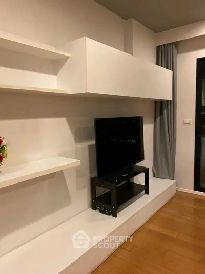 Modern living room with sleek TV setup and minimalist shelving