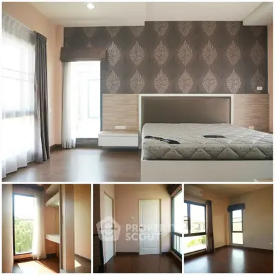 Spacious bedroom with elegant wallpaper and large windows for natural light