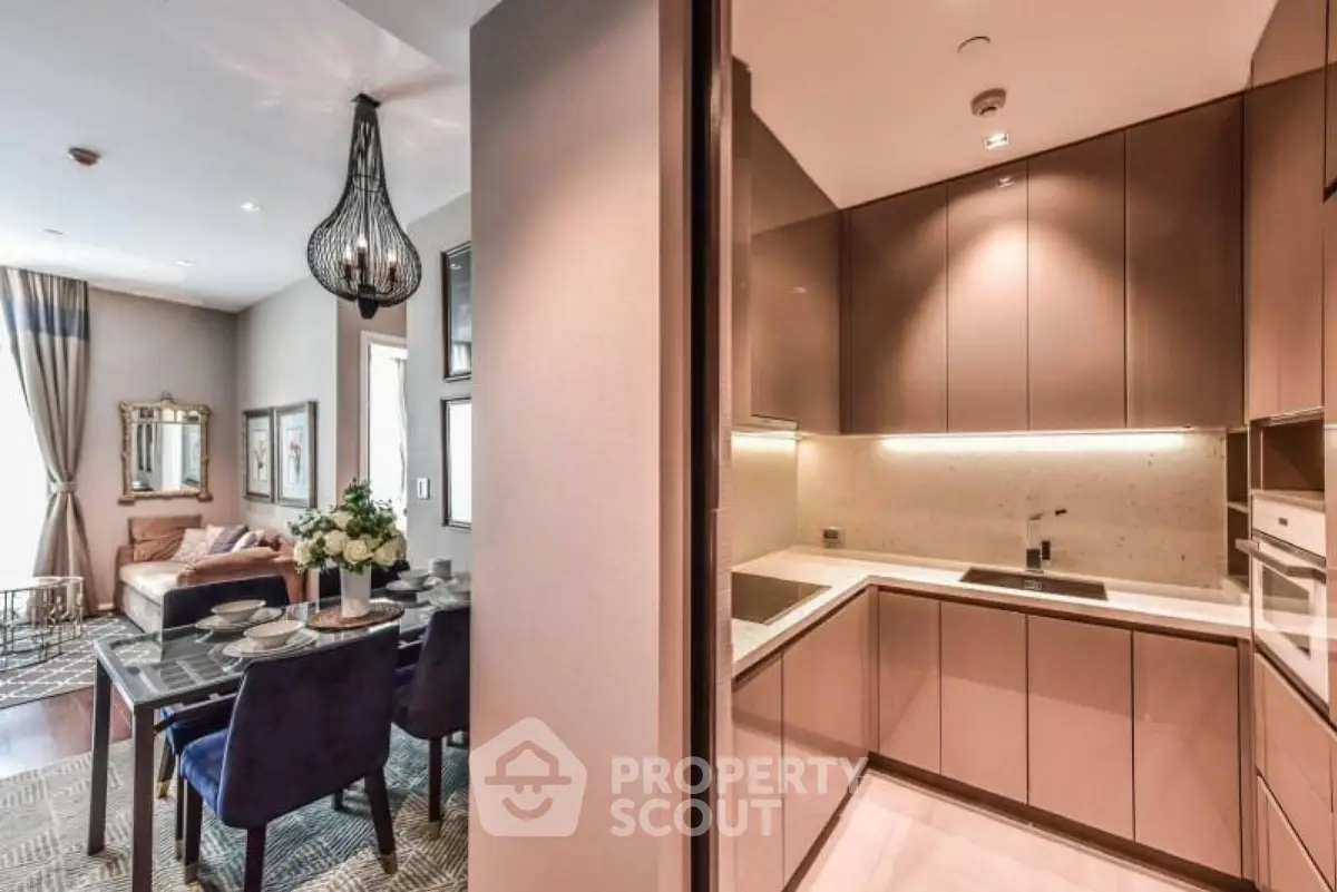 Luxurious open-plan kitchen and dining area with elegant decor and modern lighting.