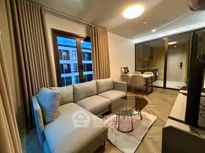 Modern living room with elegant decor and large windows in a stylish apartment.