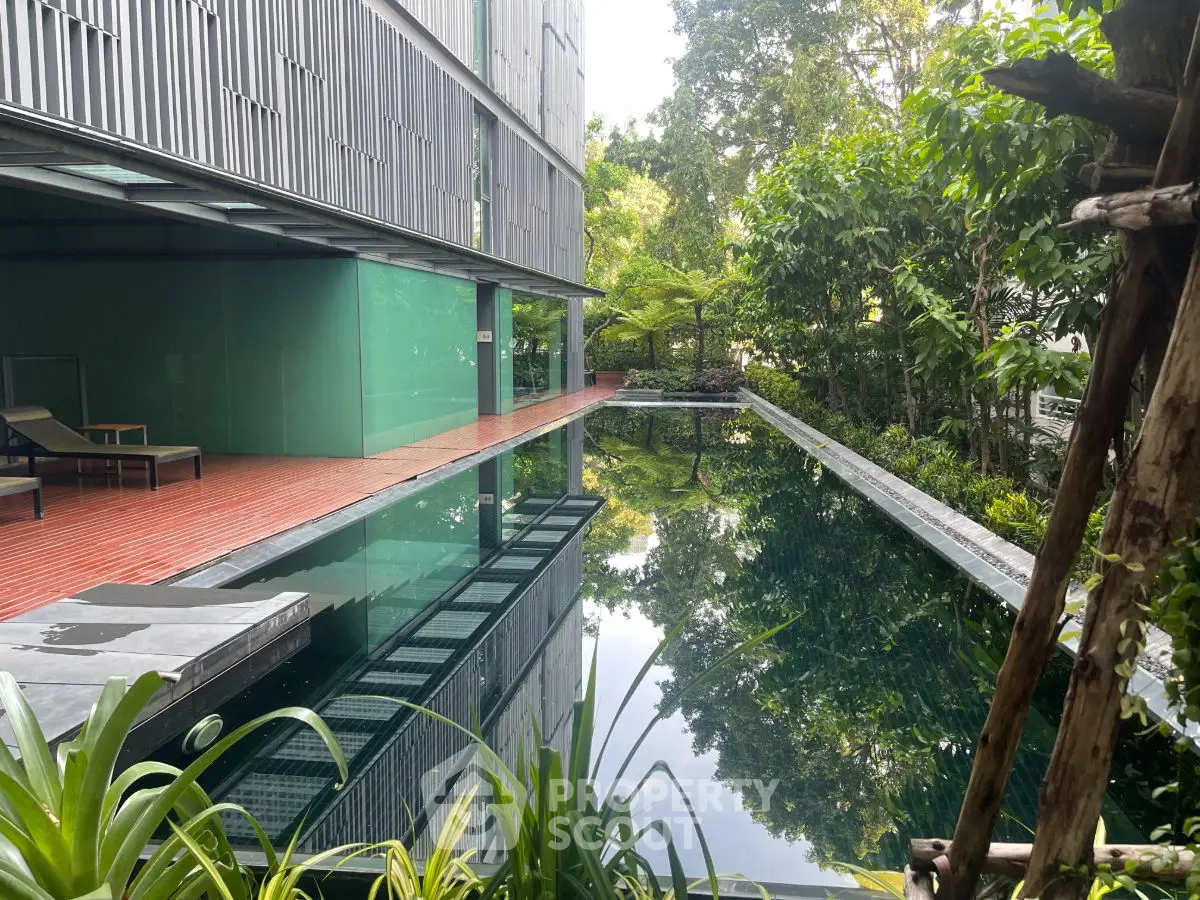 Luxurious modern apartment with serene outdoor pool and lush greenery, perfect for relaxation and leisure.